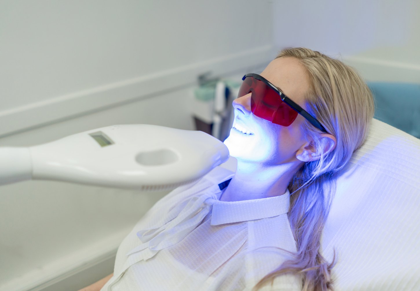 Woman getting laser teeth whitening